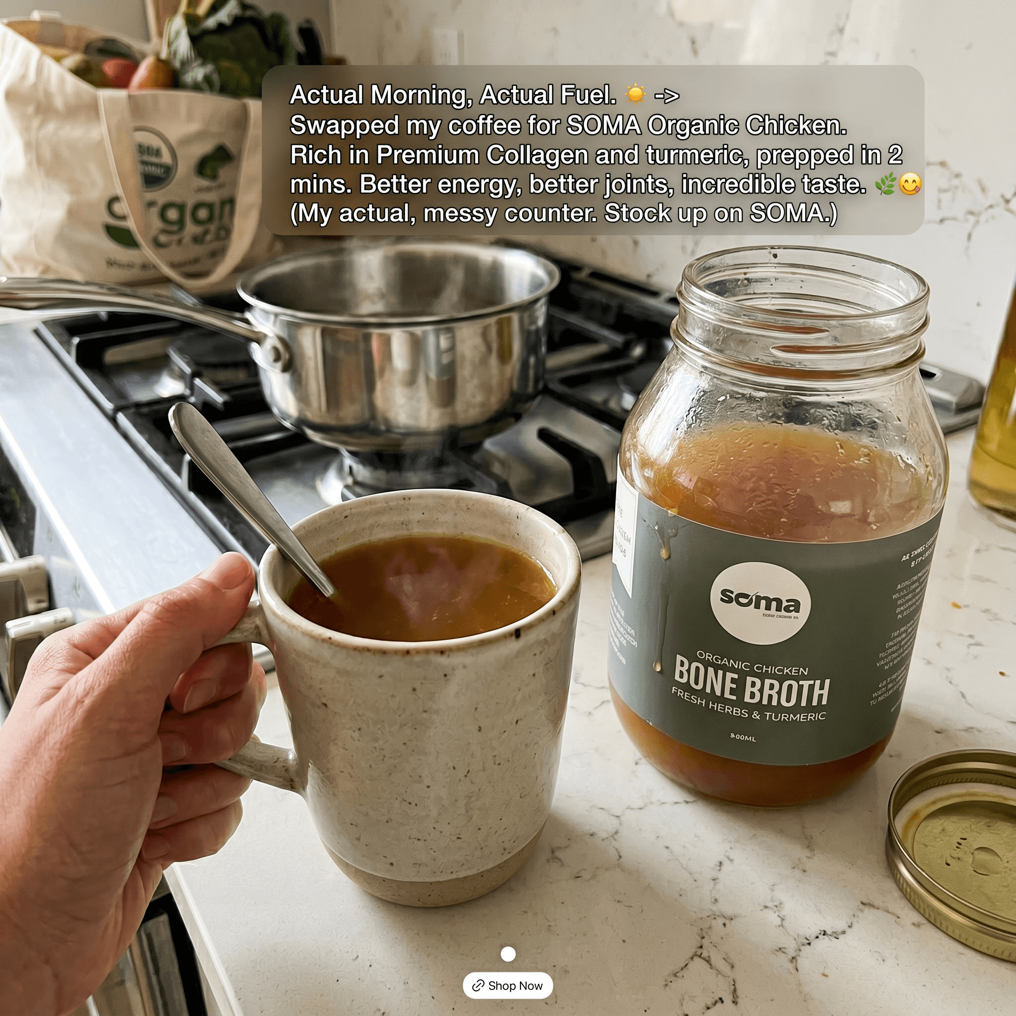 A mug of SOMA bone broth on a kitchen counter beside the jar, morning ritual